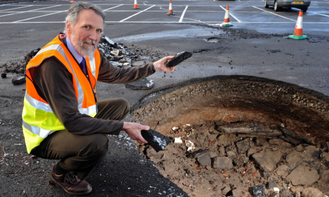 Local councillor Lewis Simpson sees the damage done during recent flooding.