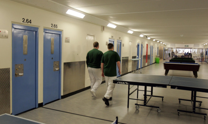 Two inmates walk along the corridor in Munro Hall  at  HMYOI, Polmont. Chief inspector of prisons, Dr Andrew McLellan   report revealed  overcrowding at the detention centre for young offenders and  was today branded "tragic" by the government's prisons inspector