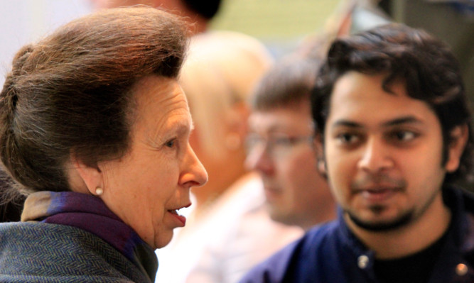 Princess Anne speaks to student Sahil Kolte at Perth Airport.