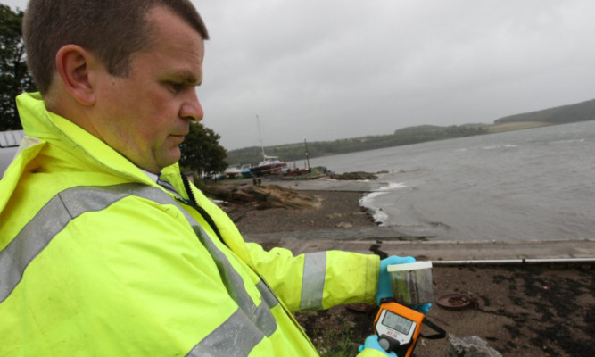 Dr Paul Dale measuring the radiation at Dalgety Bay in 2011.