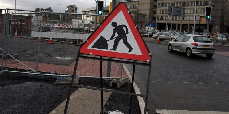 Roadworks and roadworks sign, at South Marketgait, Dundee.