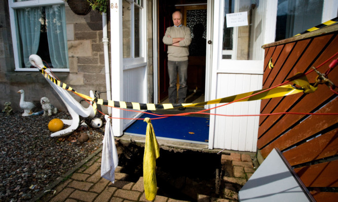 Graham Winton's  path collapsed leaving a large and dangerous hole outside his front door.