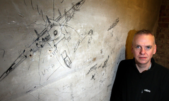 Millets manager Ian Ratcliffe beside some of the drawings. See full video below.