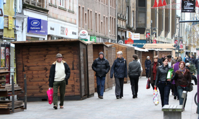 A row has erupted over stalls and wooden cabins blocking access to shops on Perth High Street.