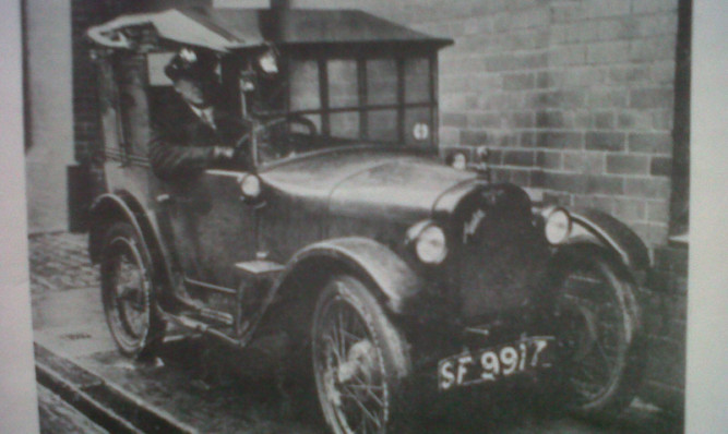 George Simpson at the wheel of the Baby Austin car.