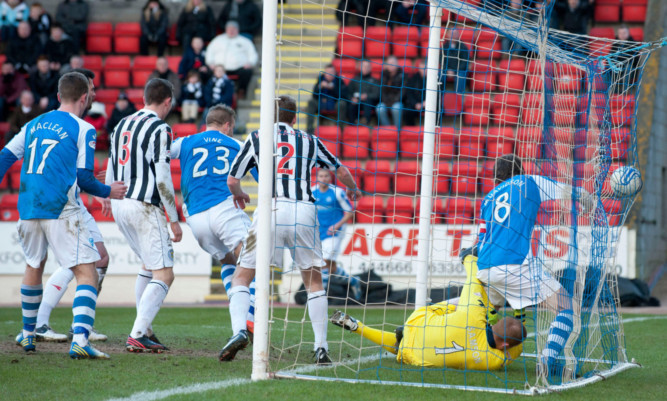 St Johnstone's Rowan Vine pounces in the box to open the scoring.