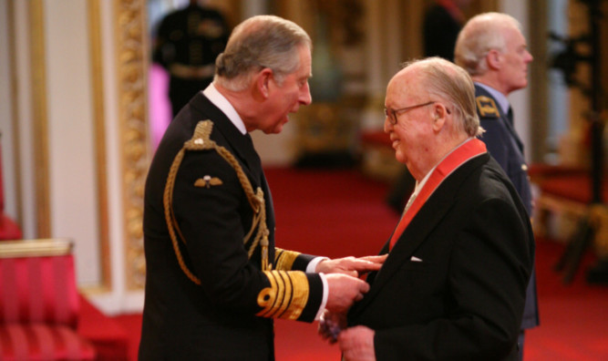 Gordon Baxter receives his CBE from the Prince of Wales at Buckingham Palace in 2010.