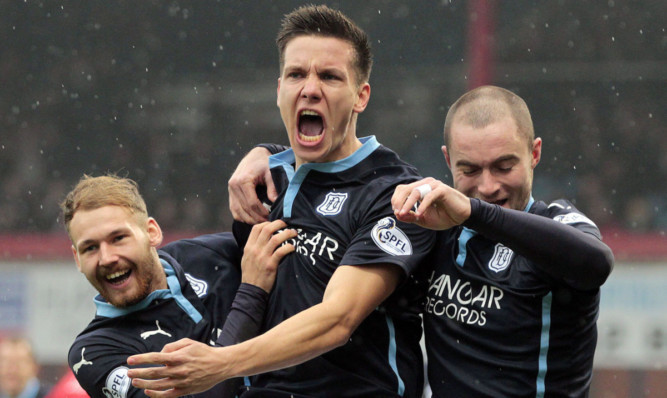 Konrad (centre) celebrates opening the scoring against Aberdeen.