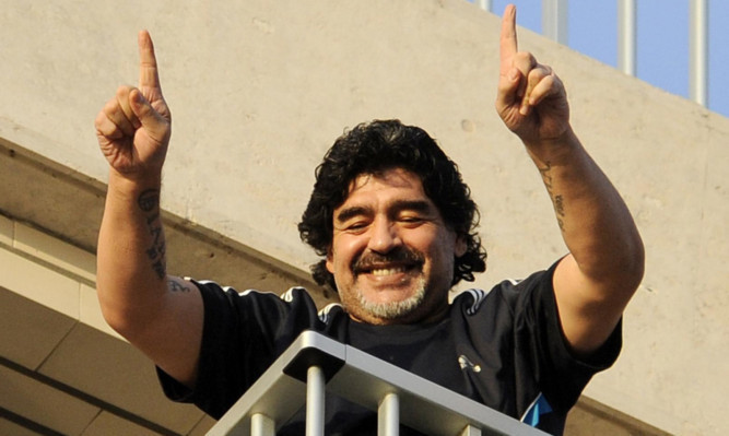 Maradona waves to fans from the balcony of a hotel in Naples.