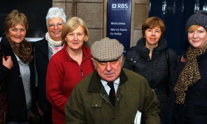 Ronnie Proctor with shopkeepers and bank service users who are unhappy about the closure of the branch on Bank Street, Kirriemuir.