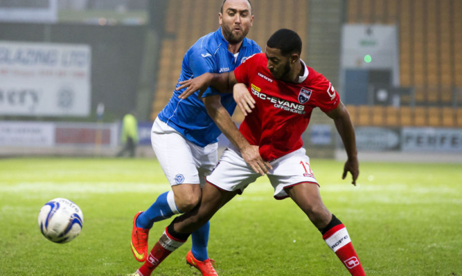 Lee Croft gets to grips with Jamie Reckord during Saturday's game.