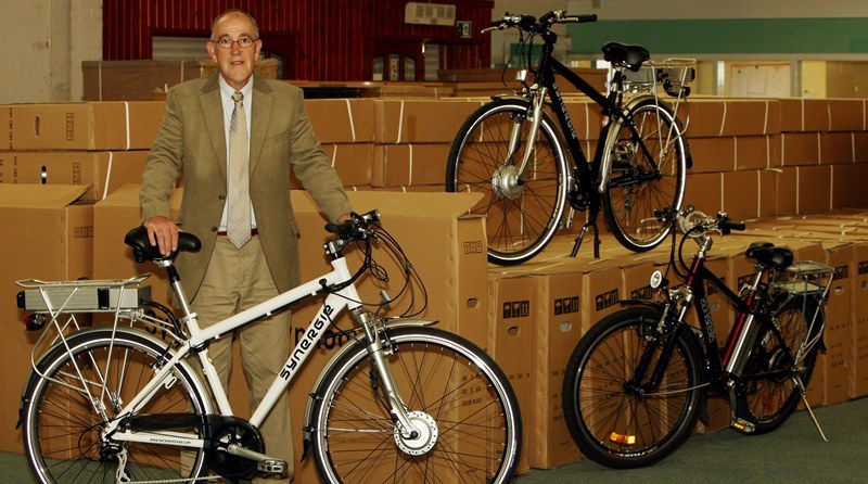 John Stevenson, Courier,08/06/10.Fife.Lochgelly,AlienOcean company making electric bikes.Pic shows AlienOcean Sales Manager Jim Stevenson with three of the current models and hundreds cretaed up and ready to be dispatched.