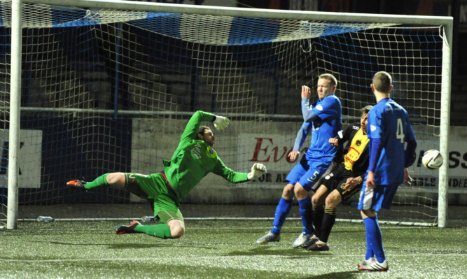 Montrose keeper Stuart McKenzie is relieved to see the ball just miss the target.