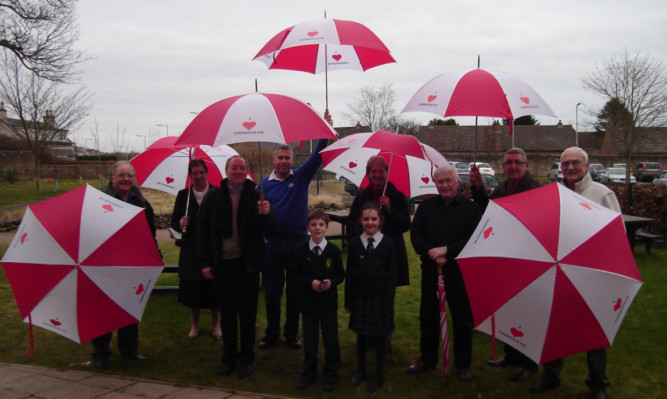 Carnoustie Development Group members, from left  Howard Evans, Mary Bushnell, Peter Burke, Brian Boyd, Provost Helen Oswald, Rodger Brunton, Ed Oswald and Arliss Rhind. Front  Woodlands Fairtrade ambassadors Callum Falconer and Lauren Sainsbury.