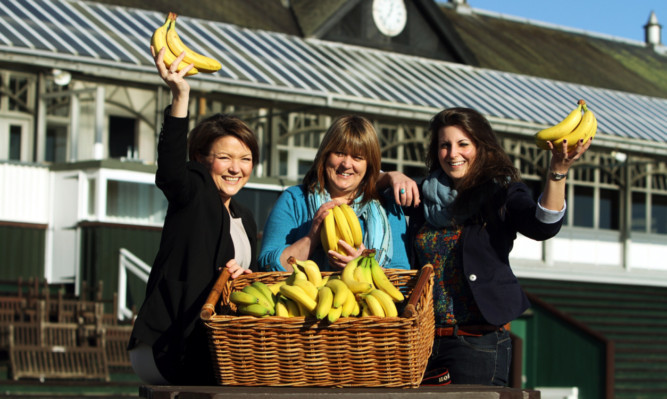 With some of the Fairtrade bananas are staff (left to right), Tracey Quinn, Morag Reid and Katy Webster.