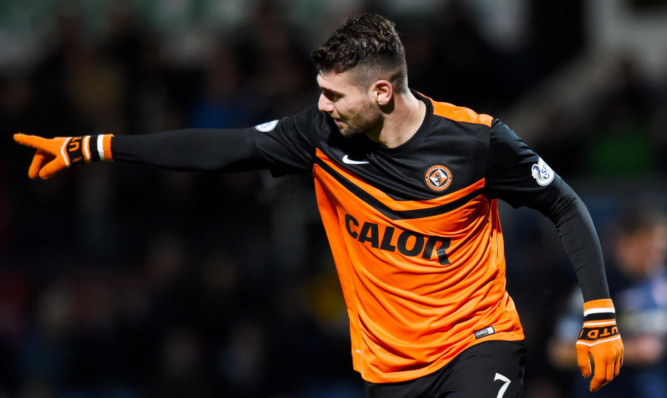 Nadir Ciftci celebrates his second and Dundee Utd's third goal of the night at Dingwall.
