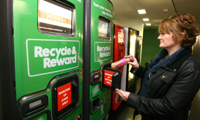 Student Debbie Morrison using one of the 'Recycle & Reward' machines.