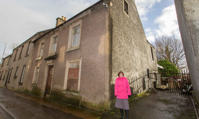 Fiona Grant outside the derelict building.