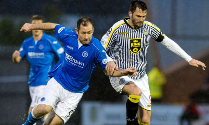 Frazer Wright battles for the ball with St Mirren's Steven Thompson.