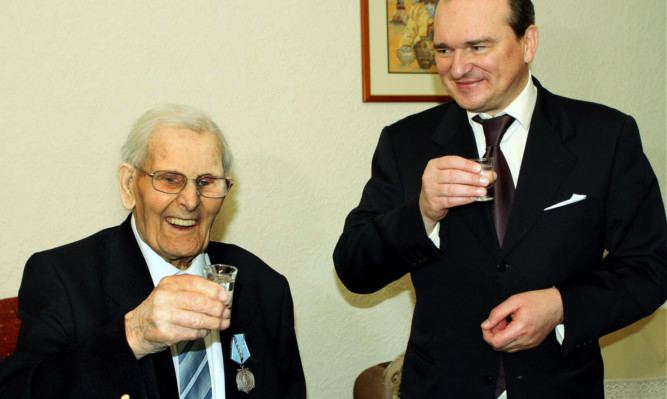 David Duke toasts his Ushakov Medal with Russian Consul General Andrey Pritsepov.