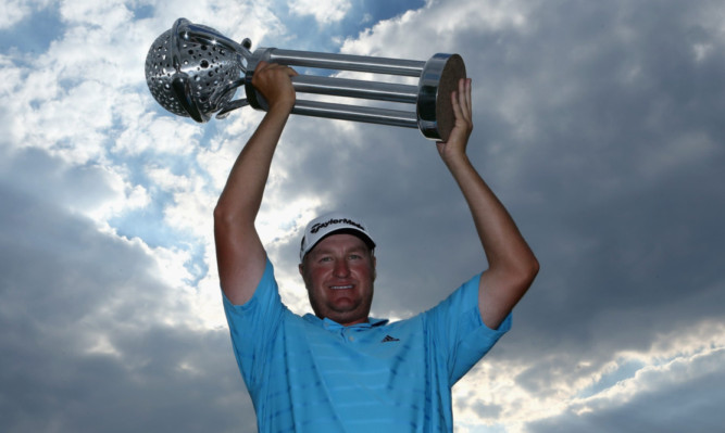 Dawie Van Der Walt poses with the trophy after winning the Tshwane Open at Copperleaf Golf & Country Estate in Centurion, South Africa.