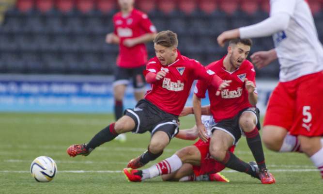 Josh Falkingham is floored by a tackle as Dunfermline try to get back in the game.