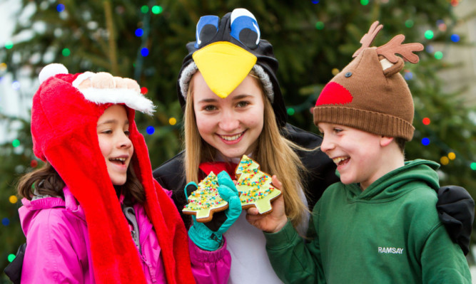 Enjoying homemade Christmas treats are  Faye Saba, 8, Romy McMillan, 14, and Ramsay MacEwan, 9.