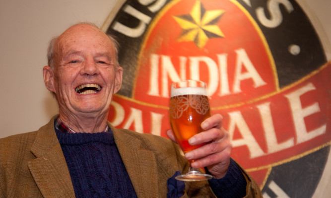 Stuart Usher tastes the first brew of the resurrected beer.