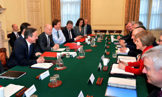 Prime Minister David Cameron sits opposite First Minister Nicola Sturgeon at the meeting.