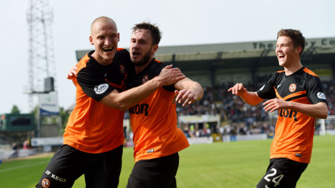Dundee Utd's Keith Watson (centre) celebrates with team-mate Jaroslaw Fojut after scoring for his side in the first game between the teams this season.