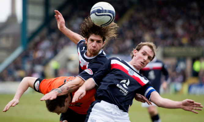 Dundee pair David Grassi (centre) and Gary Irvine crowd out Jon Daly