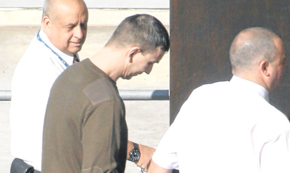 Security guards escort George Cameron at a previous court appearance.