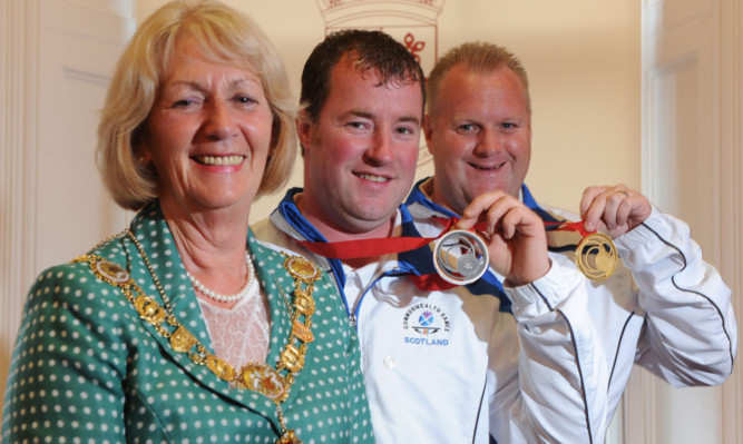 Provost Helen Oswald with Commonwealth Games medal winners Drew Christie, centre, and Darren Burnett.