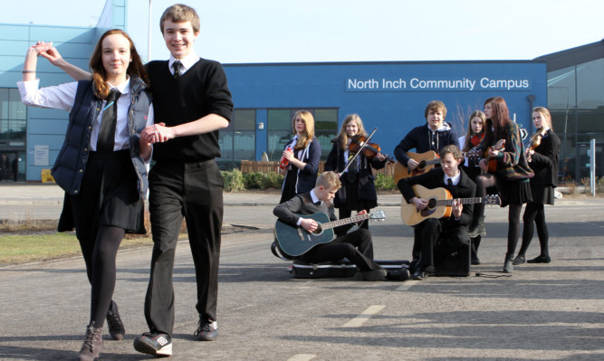 Frances Lole and William MacSween dance whilst other pupils play their instruments.