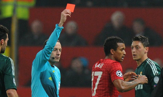 Nani receives a red card from referee Cuneyt Cakir.