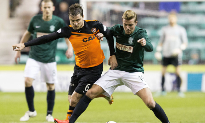 Dundee Utd's Paul Paton wrestles for the ball with Hibs' Danny Handling