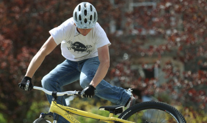 A Clan Cycle stunt team member takes part in a Highland Perthshire Cycling Festival event.