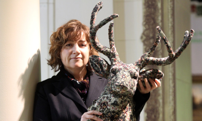 Debbie Lawson with one of her award-winning pieces, a Persian stag.