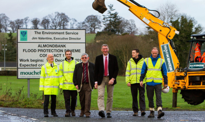 From left: structures and flood manager Drew Strang, Mouchel site supervisor Iain MacKenzie, Councillor Alan Grant, Councillor Mike Williamson, flooding engineer Russell Stewart and Mackenzie Construction site agent Jonathan Hall.