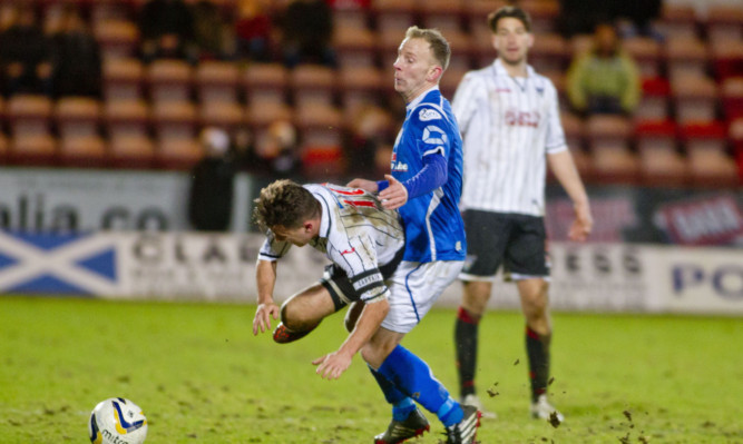 Pars captain Josh Falkingham is sent flying by Chris Aitken.