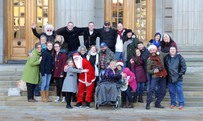 On the steps of the Caird Hall are some of the people who have participated in the Humans of Dundee project.