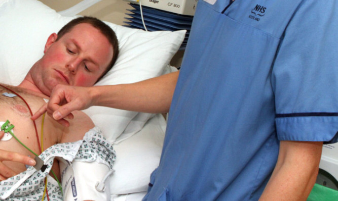 An ECG is set up on a patient at Ninewells Hospital.