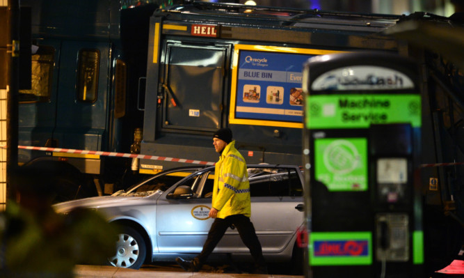 Emergency services attend the scene of the crash in George Square.