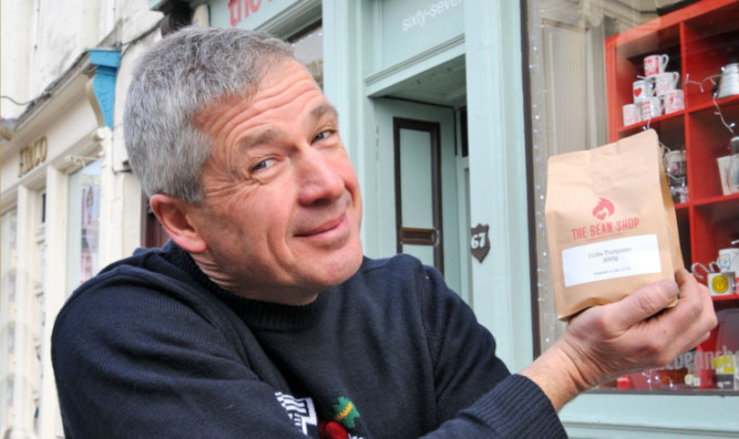 John Bruce of the Bean Shop in Perth with the Cuban coffee beans that have caused a controversy.