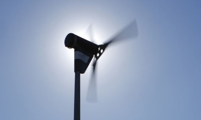 A wind turbine spins as the sun burst out of a clear blue sky. PRESS ASSOCIATION Photo. Picture date: Monday March 8, 2010. Photo credit should read: Chris Ison/PA Wire.