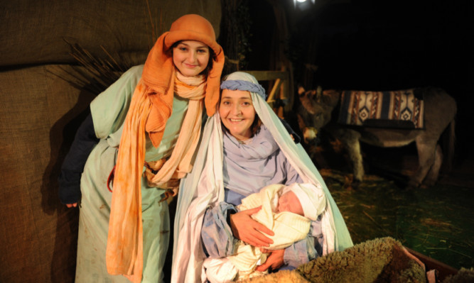 Donna with baby Jacob and her daughter Joy in the nativity.