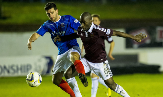 Hearts Morgaro Gomis fights for the ball with Colin Marshall.