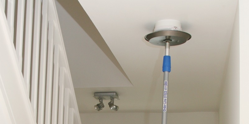 Home fire safety:   Firefighter Bruce Alexander fits a smoke alarm watched by colleague Henry Hay and Lee MacKay.