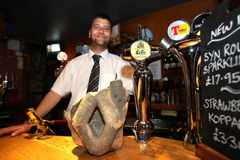 Kris Miller, Courier, 20/06/10, News. Picture today at Royal Arch pub in Broughty Ferry. Pic shows assistant manager Richard McKay in the pub with the piece of the original Royal Arch from Dundee's docks.