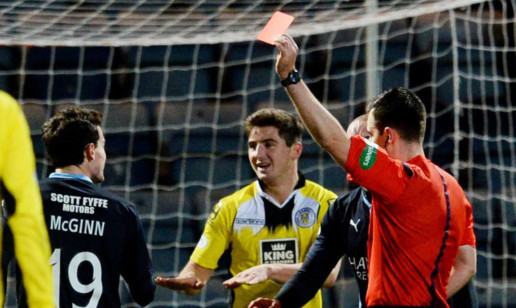 Paul McGinn is shown a red card.
